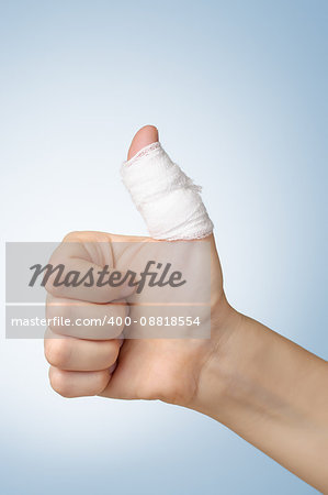 Injured painful finger with white bandage