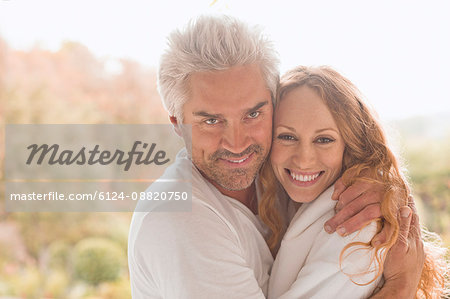 Portrait smiling affectionate couple hugging outdoors