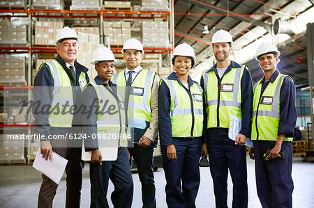 Portrait confident managers and workers in distribution warehouse