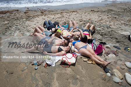 Group of young women sunbathing on beach, Block Island, Rhode Island, USA