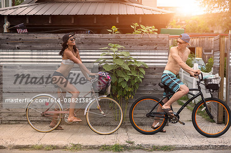 Young couple on bicycles, Rockaway Beach, New York State, USA