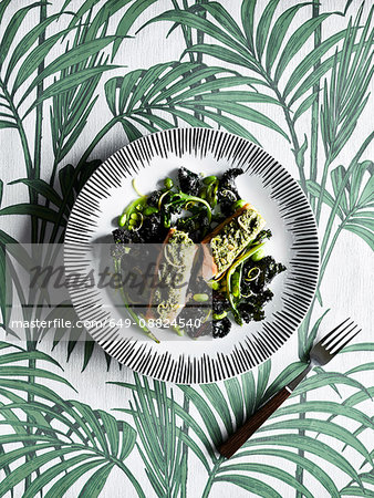 Plate of vegetable, on palm-leaf pattern background