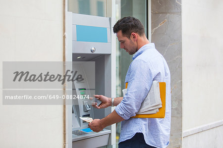 Man withdrawing cash from cash machine