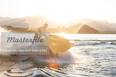 Man riding jet ski on lake, Beijing, China