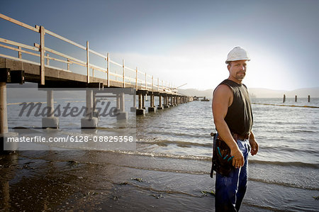 View of a mature man standing near sea.