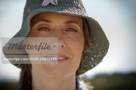 Portrait of a mature woman wearing a sun hat.