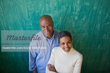 Portrait of a smiling mid-adult couple standing next to each other.