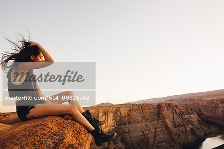 Woman relaxing and enjoying view, Horseshoe Bend, Page, Arizona, USA