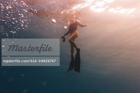 Woman treading water near surface of sea