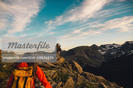 Women on rocky outcrop looking at view, Rocky Mountain National Park, Colorado, USA