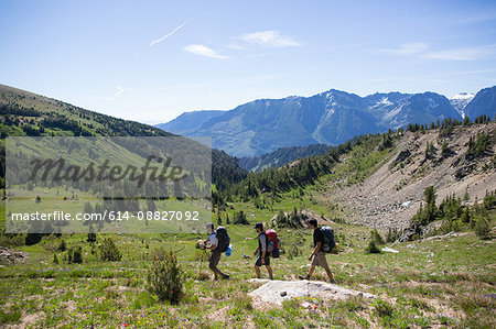 Hikers walking across valley, Enchantments, Alpine Lakes Wilderness, Washington, USA