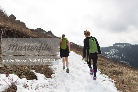 Two young women hiking along mountain-side, rear view, Silver Star Mountain, Washington, USA