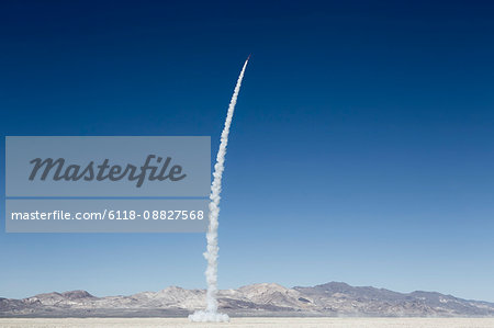 Rocket shooting into vast, desert sky, Black Rock Desert, Nevada