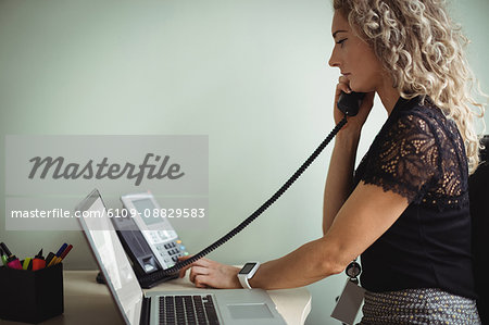 Businesswoman talking on landline