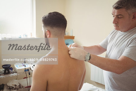 Physiotherapist performing dry needling on patient