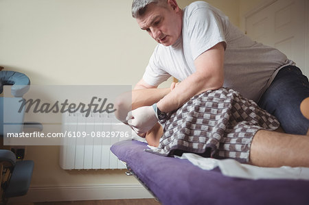 Physiotherapist examining back of a patient