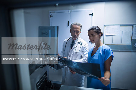 Doctor and nurse examining a x-ray