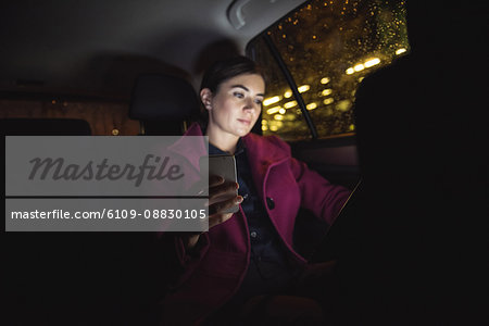 Businesswoman using digital tablet and phone
