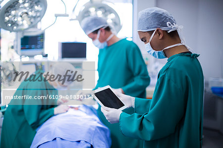 Surgeon using digital tablet in operation theater