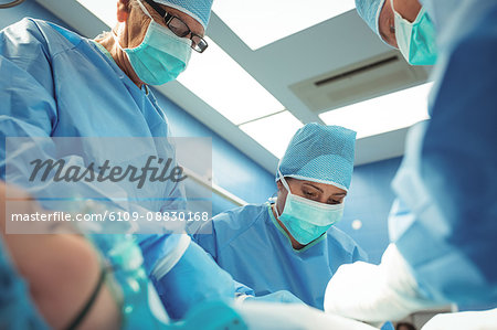 Team of surgeons performing operation in operation theater