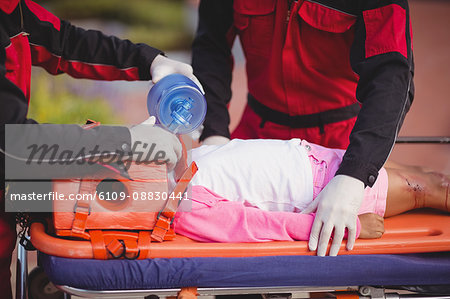 Paramedic giving oxygen to injured girl