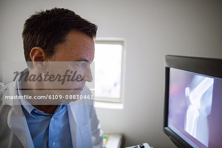 Doctor examining x-ray on personal computer