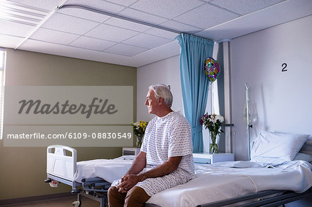 Thoughtful male senior patient sitting in the ward