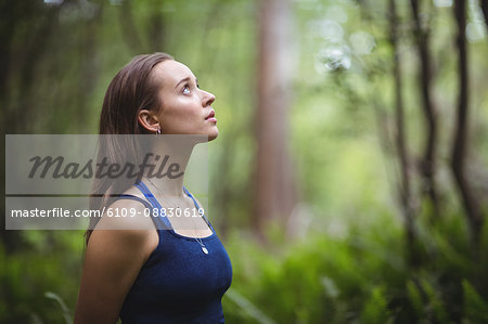 Woman performing yoga in forest