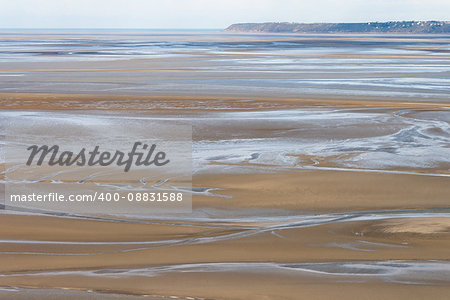 Sea coast at low tide. The tides can vary greatly, at roughly 14m between high and low water marks. One of France's most recognizable landmarks. View from the top of the mount Saint Michael's, France