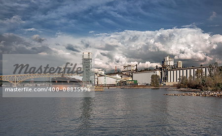 Ship under loading in   Vancouver's  port on the background of cloudy sky