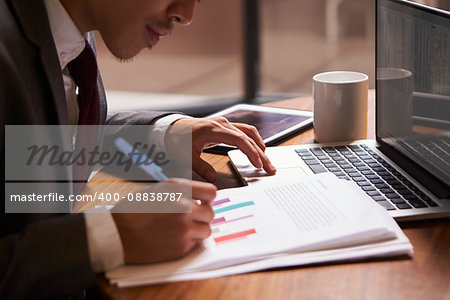 Businessman preparing a document, close up, side view