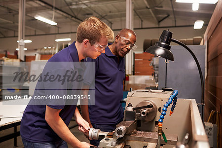 Engineer Training Male Apprentice On Milling Machine