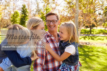 Young white family having fun together in a park