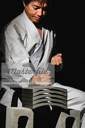 Japanese karate master breaking tiles