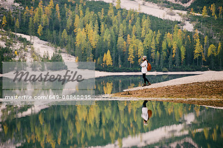 Woman enjoying view, Lago di Braies, Dolomite Alps, Val di Braies, South Tyrol, Italy