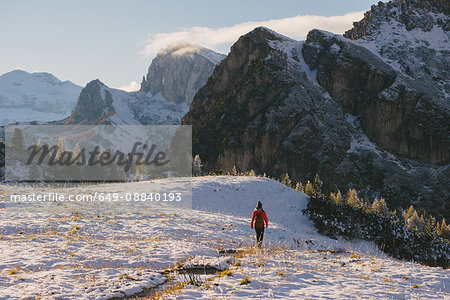 Young woman walking across landscape, Limides Lake, South Tyrol, Dolomite Alps, Italy