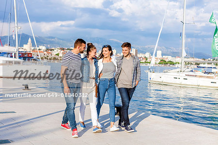 Young couples strolling on harbour, Split, Dalmatia, Croatia