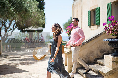 Couple on stairway at boutique hotel, Majorca, Spain