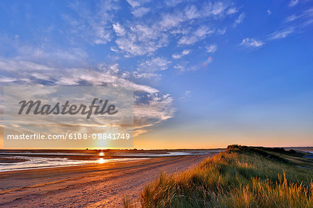 France, Normandy. View of the Regneville-sur-mer Bay and Agon-Coutainville at sunset. High tides period