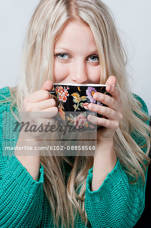 Portrait of young woman with coffee cup