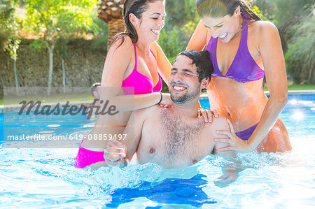 Friends fooling around in swimming pool