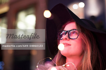 Young woman enjoying bright neon lights of street, London, UK