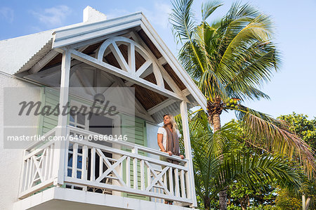Mature woman standing on balcony of house, Roches Noire, Mauritius