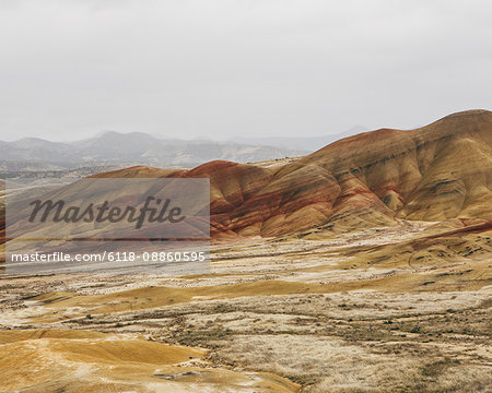 The landscape of the John Day Fossil Beds National Monument, Oregon. Vivid coloured rock strata. Mountains.