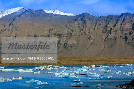 Tourist boat in icebergs in the Jokulsarlon glacial lake in Vatnajokull National Park in southeast Iceland, Polar Regions