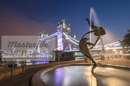 The Girl With A Dolphin Fountain frames Tower Bridge reflected in the River Thames at night, London, England, United Kingdom, Europe The Girl With A Dolphin Fountain frames Tower Bridge reflected in the River Thames at night, London, England, United Kingdom, Europe