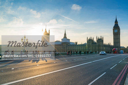 Pedestrians on Westminster Bridge with Houses of Parliament and Big Ben at sunset, London, England, United Kingdom, Europe