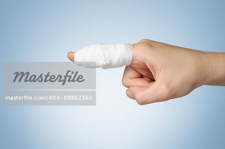 Injured painful finger with white gauze bandage