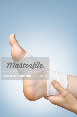 Injured painful foot with white gauze bandage