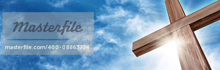 Wooden Cross with a Bright Blue Sky and Sun